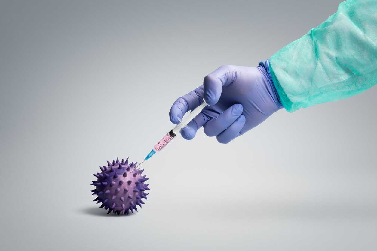 Health worker  injecting vaccine into a pathogen like viruses and bacteria