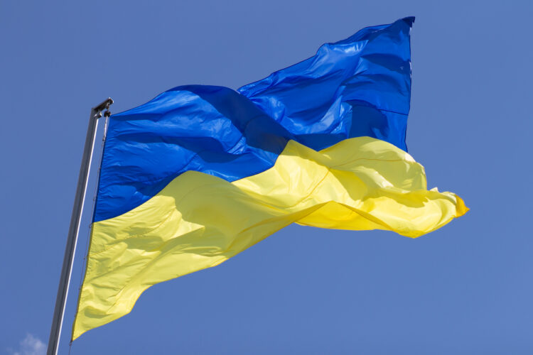 Ukrainian blue and yellow national flag waving in the air against sky