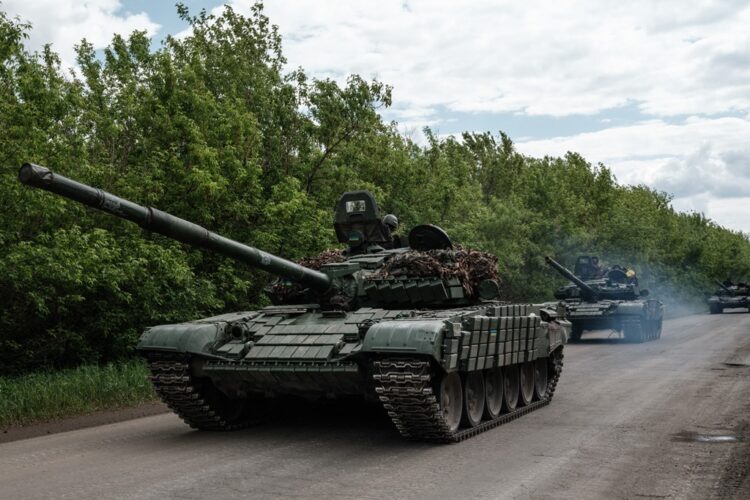 Ukrainian main battle tanks drive on a road near Bakhmut, eastern Ukraine, on May 15, 2022, amid the Russian invasion of Ukraine. (Photo by Yasuyoshi CHIBA / AFP)